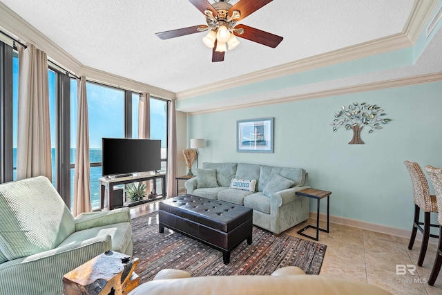 living room featuring a textured ceiling, ceiling fan, crown molding, and light tile patterned flooring