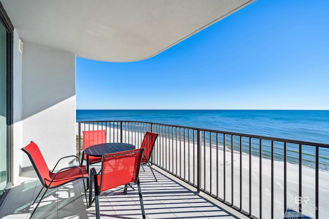 balcony with a view of the beach and a water view