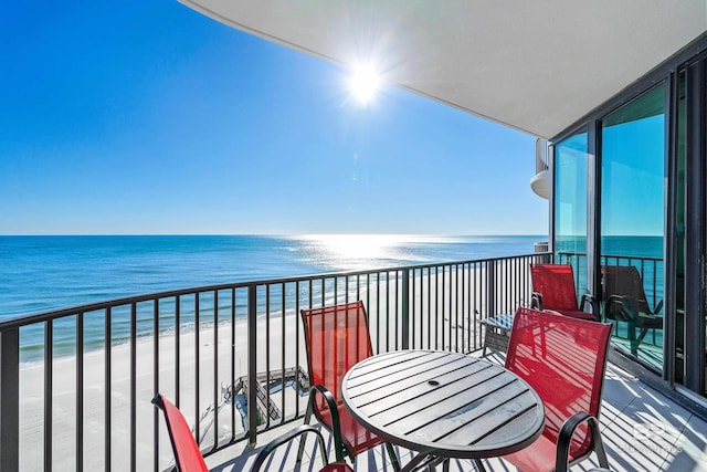 balcony with a water view and a beach view