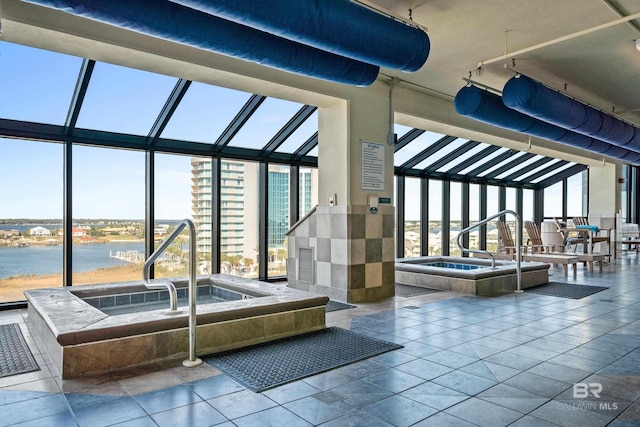 interior space with a water view and an indoor hot tub