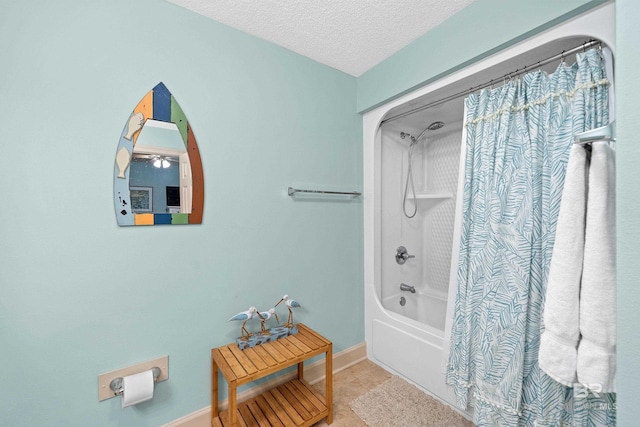 bathroom featuring a textured ceiling and shower / tub combo