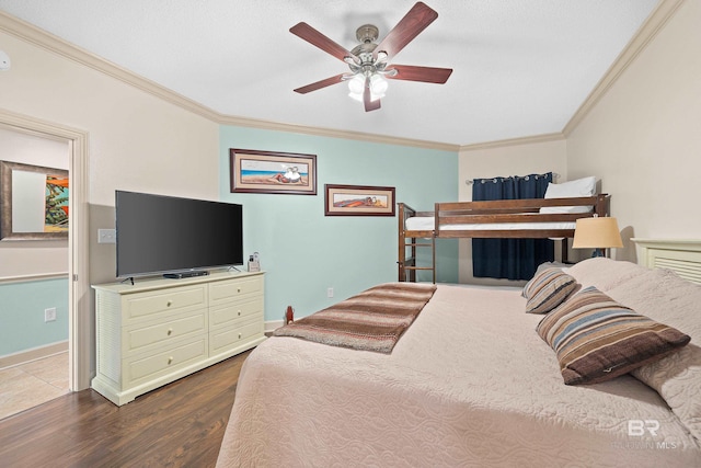 bedroom featuring ceiling fan, crown molding, and hardwood / wood-style flooring