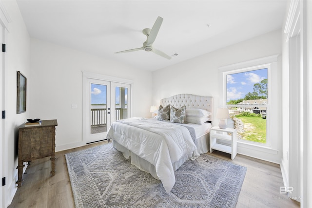 25995 W Perdido Ave, Orange Beach, AL 36561 - bedroom featuring access to exterior, light wood finished floors, french doors, and ceiling fan