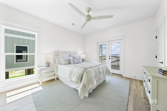 25995 W Perdido Ave, Orange Beach, AL 36561 - bedroom with french doors, light wood-style flooring, access to outside, and multiple windows