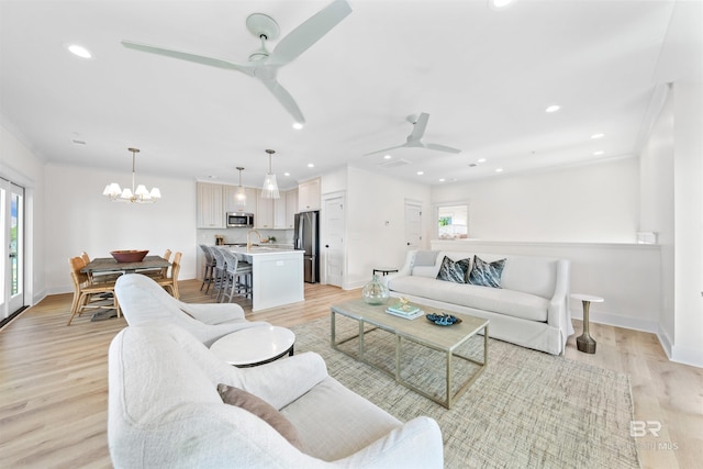 25995 W Perdido Ave, Orange Beach, AL 36561 - living area with ceiling fan, a chandelier, light wood-type flooring, and recessed lighting