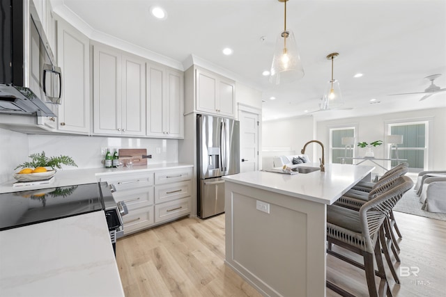 25995 W Perdido Ave, Orange Beach, AL 36561 - kitchen with appliances with stainless steel finishes, recessed lighting, light wood-style floors, light countertops, and pendant lighting