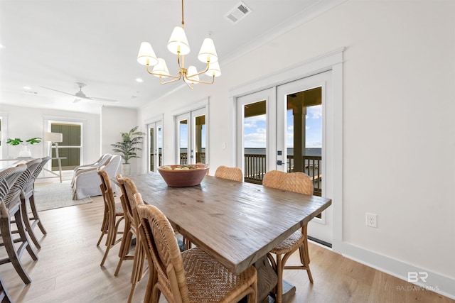 25995 W Perdido Ave, Orange Beach, AL 36561 - dining room featuring french doors, light wood finished floors, recessed lighting, a chandelier, and a ceiling fan