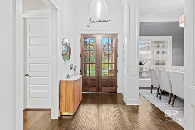 foyer with french doors, dark hardwood / wood-style flooring, and crown molding