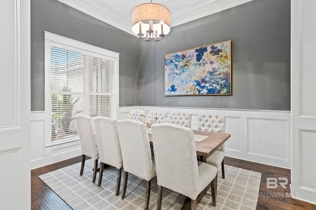 dining space featuring dark hardwood / wood-style flooring, a chandelier, and ornamental molding