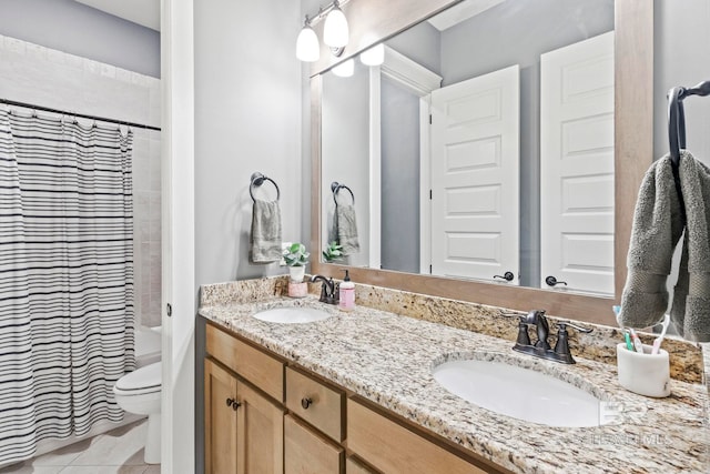 bathroom with tile patterned floors, vanity, toilet, and curtained shower