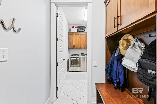 mudroom featuring light tile patterned flooring and independent washer and dryer