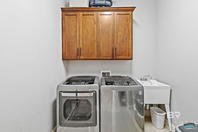 washroom featuring cabinets and washer and dryer