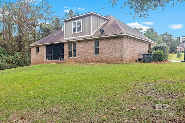 rear view of property with a lawn