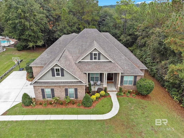 craftsman house with a front yard and covered porch