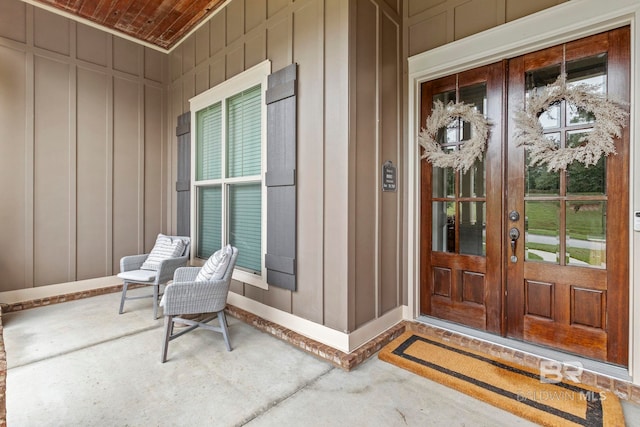 doorway to property featuring covered porch and french doors