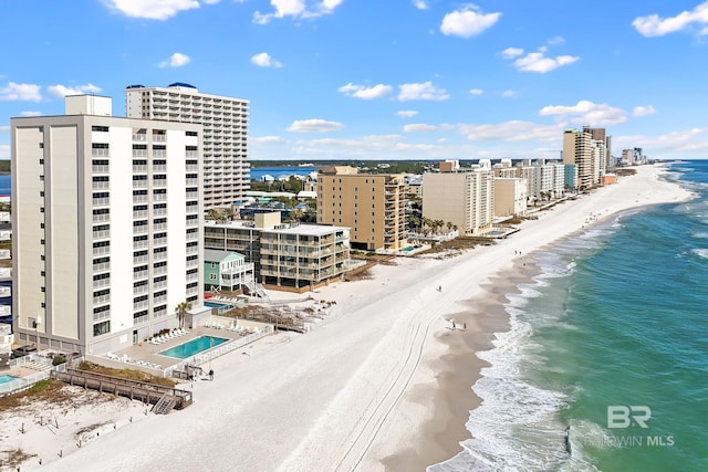 drone / aerial view featuring a water view and a beach view