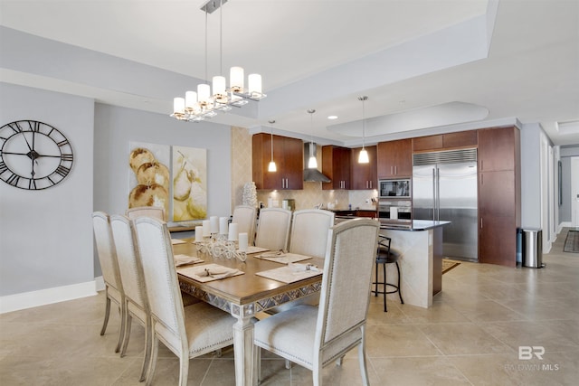 dining room featuring light tile patterned floors, a chandelier, recessed lighting, baseboards, and a tray ceiling