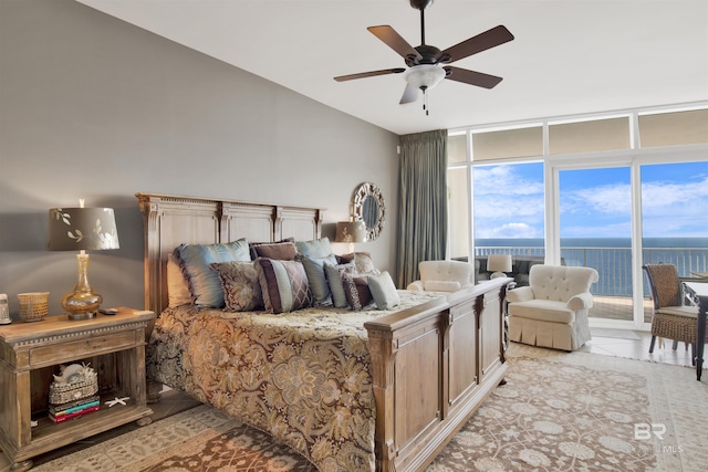 bedroom featuring light tile patterned floors, ceiling fan, a water view, access to outside, and floor to ceiling windows