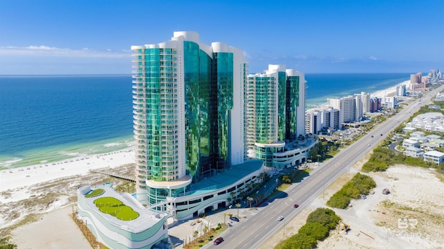 bird's eye view featuring a water view, a view of the beach, and a city view