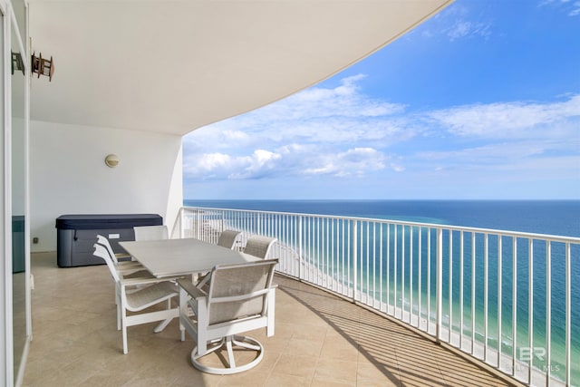 balcony featuring a water view and outdoor dining space