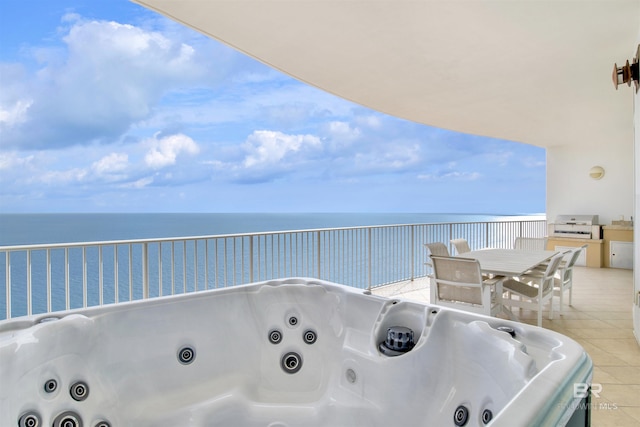 view of patio featuring outdoor dining space, a water view, a grill, and a hot tub