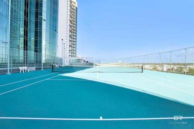 view of sport court featuring fence