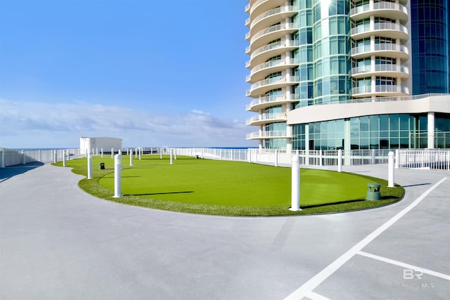 view of home's community featuring fence