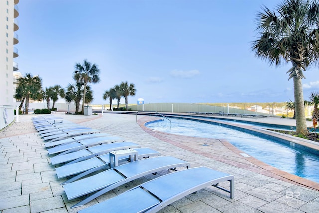 pool featuring a patio area and fence