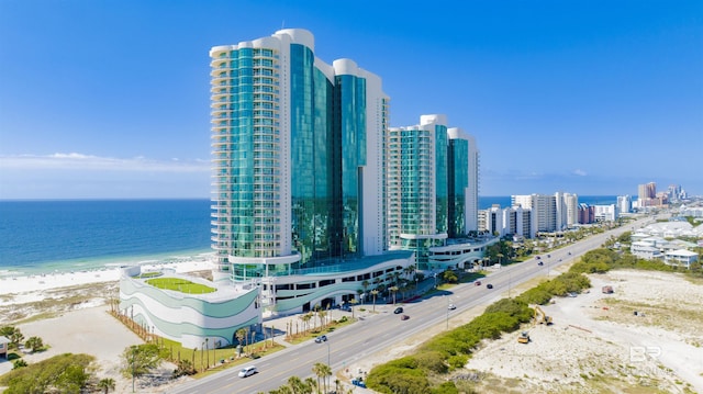 exterior space with a water view, a view of city, and a view of the beach