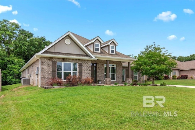 view of front of home with brick siding, a front lawn, central air condition unit, and board and batten siding