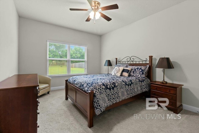carpeted bedroom with baseboards and a ceiling fan