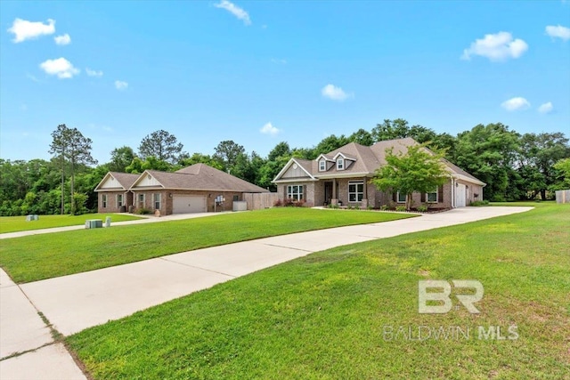 view of front of house featuring a garage, driveway, a front lawn, and brick siding