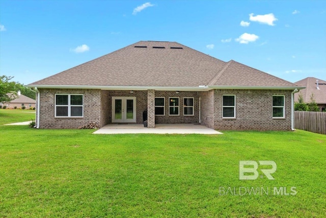 back of property with french doors, a patio, roof with shingles, and brick siding