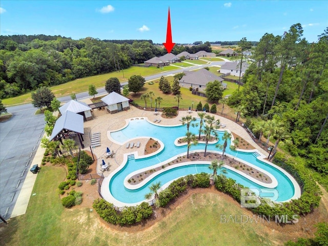bird's eye view of a pool area and a forest