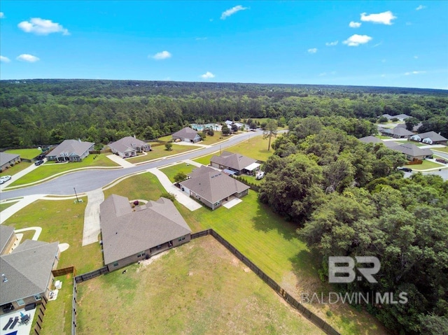 aerial perspective of suburban area with a heavily wooded area