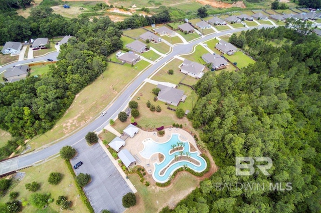 aerial overview of property's location with a pool and nearby suburban area
