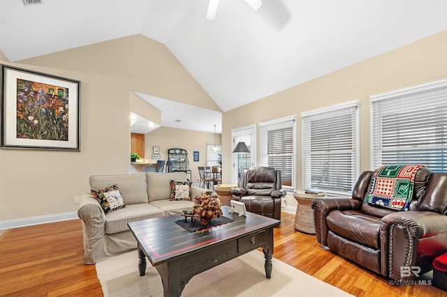 living room featuring light wood-type flooring, vaulted ceiling, and ceiling fan