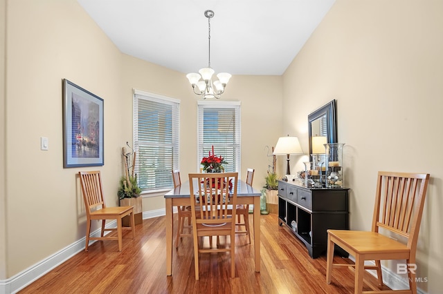 dining space featuring a chandelier and wood-type flooring