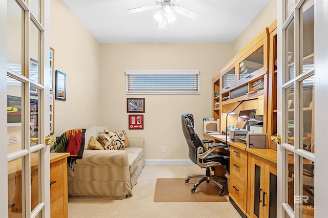 home office featuring light carpet and ceiling fan