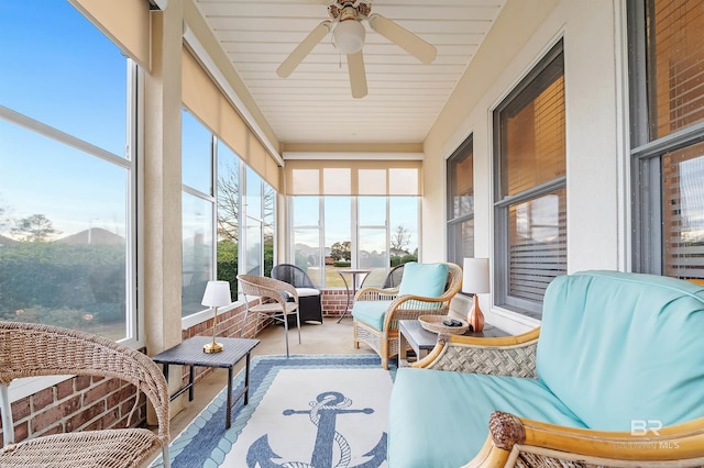 sunroom featuring ceiling fan and a healthy amount of sunlight