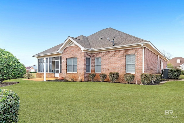 back of property featuring a lawn and a sunroom