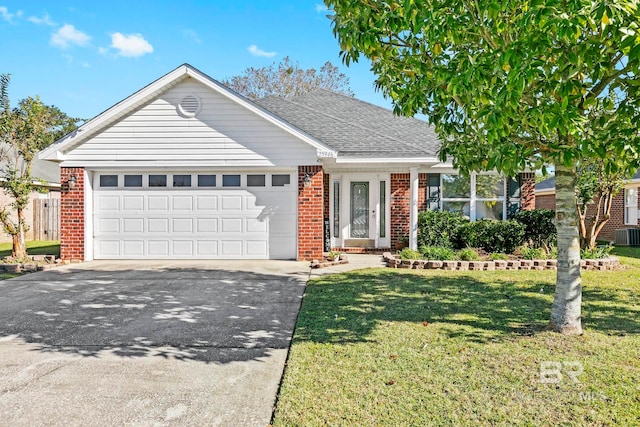 view of front facade with a front yard and a garage