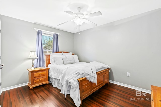 bedroom with dark hardwood / wood-style flooring and ceiling fan