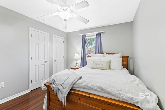 bedroom with dark hardwood / wood-style flooring and ceiling fan