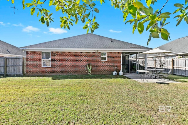 back of house featuring a yard and a patio