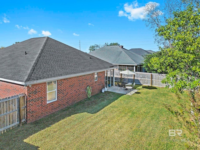 back of property featuring a yard and a patio