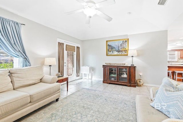 living room with light tile patterned floors and ceiling fan