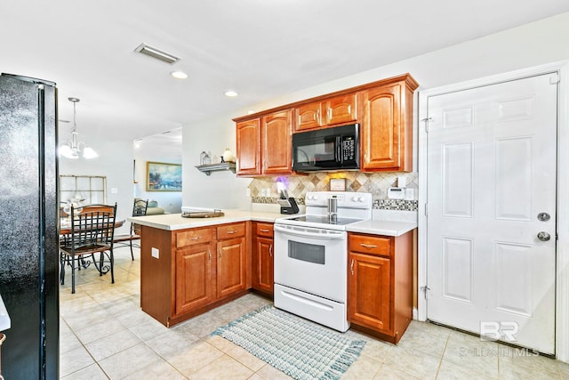 kitchen featuring kitchen peninsula, black appliances, light tile patterned floors, decorative light fixtures, and a chandelier