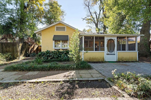 view of front of home with a sunroom and a patio area