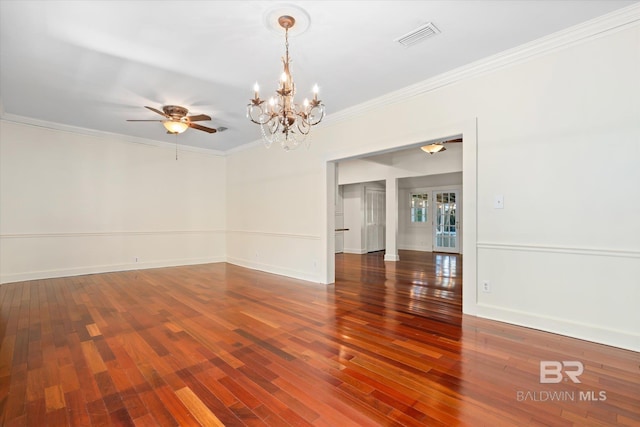 empty room with ceiling fan with notable chandelier, wood-type flooring, and crown molding